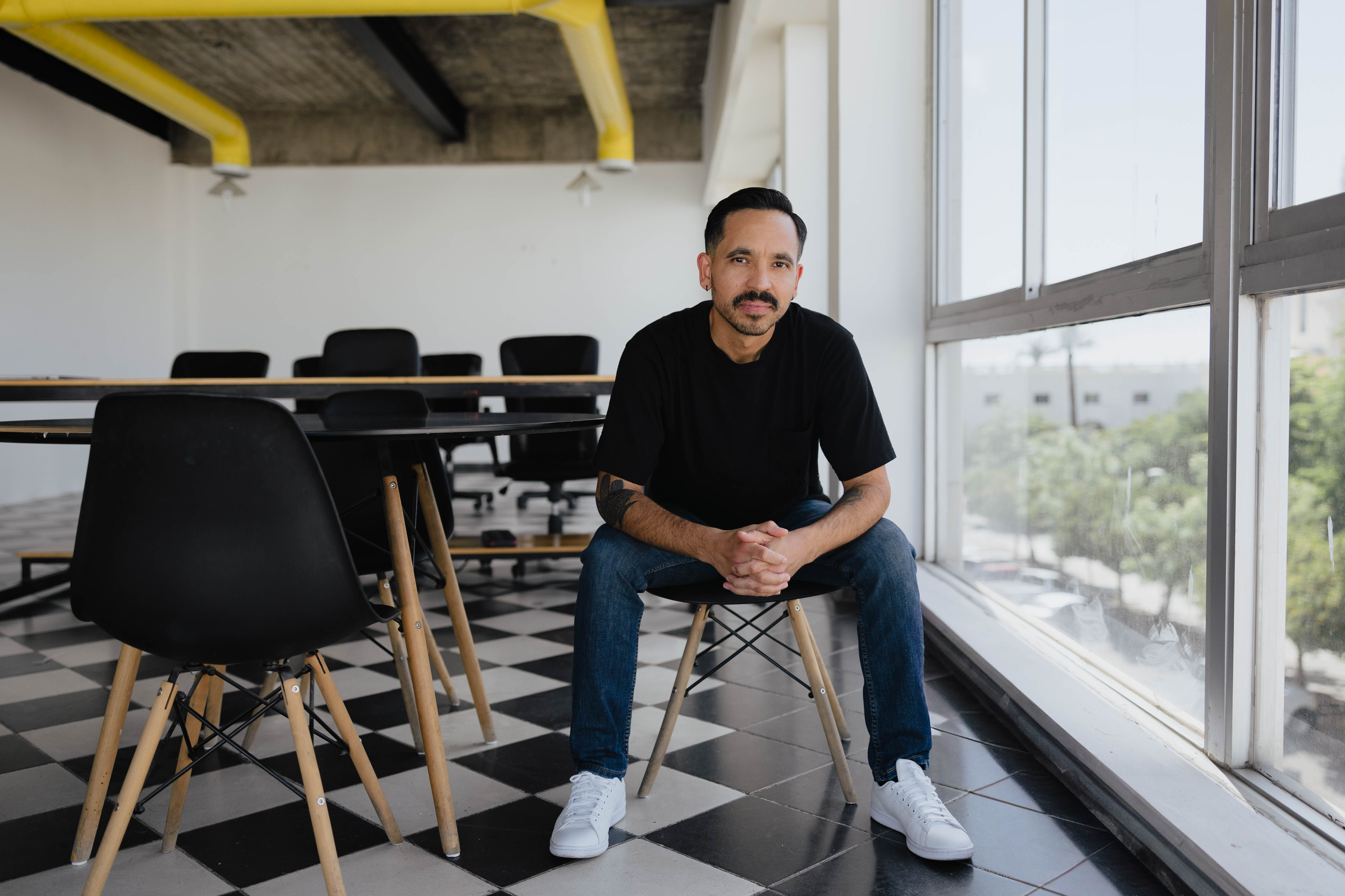 Portrait of Isaac Durazo sitting on a chair